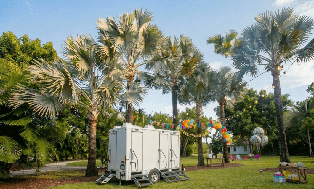 Luxury portable restroom trailer at outdoor birthday party venue with palm trees and balloons in Florida – YML